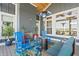 Covered patio featuring a stone fireplace, seating area, and view of the water at 10590 Geist View Dr, Fishers, IN 46055