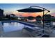 Inviting pool area with lounge chairs, umbrella, and tranquil water views, creating a perfect setting for relaxation and recreation at 10590 Geist View Dr, Fishers, IN 46055