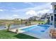 An inviting pool is surrounded by manicured lawn and potted plants, perfect for relaxation and entertainment at 10590 Geist View Dr, Fishers, IN 46055