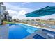 A sparkling pool overlooks the lake on a sunny day, offering a refreshing outdoor retreat at 10590 Geist View Dr, Fishers, IN 46055