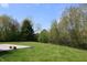 Expansive backyard and concrete patio space backed by a lush tree line at 109 Buckthorne Ln, Mooresville, IN 46158