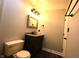 Modern bathroom with vanity, framed mirror, toilet and black fixtures at 109 Buckthorne Ln, Mooresville, IN 46158