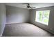 Spacious bedroom featuring neutral walls, carpet, ceiling fan and a bright window at 109 Buckthorne Ln, Mooresville, IN 46158