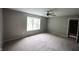 Carpeted bedroom featuring neutral walls, ceiling fan and a bright window at 109 Buckthorne Ln, Mooresville, IN 46158