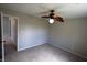 Bedroom with neutral walls, carpet, ceiling fan and a doorway leading to other parts of the home at 109 Buckthorne Ln, Mooresville, IN 46158