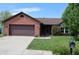 Inviting single-story home with a brick facade, attached garage, and a meticulously landscaped front yard at 109 Buckthorne Ln, Mooresville, IN 46158