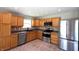 Well-lit kitchen featuring stainless steel appliances, wood cabinets, and neutral countertop at 109 Buckthorne Ln, Mooresville, IN 46158