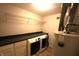 Laundry room with side-by-side washer and dryer, counter space, and storage shelving at 109 Buckthorne Ln, Mooresville, IN 46158