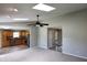 Open living space with neutral tones and a view of the kitchen, featuring a brick fireplace at 109 Buckthorne Ln, Mooresville, IN 46158