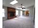 Open living area with a brick fireplace, sliding doors, and a glimpse into the adjacent kitchen at 109 Buckthorne Ln, Mooresville, IN 46158