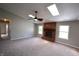 Bright and spacious living room featuring a brick fireplace, ample natural light, and plush carpeting at 109 Buckthorne Ln, Mooresville, IN 46158