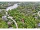Aerial view showing a home with mature trees, a private location, and nearby lake access in a wooded neighborhood at 10919 Running Tide Ct, Indianapolis, IN 46236