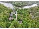 Breathtaking aerial view showcasing a home in a wooded community near a lake, blending natural beauty with luxury living at 10919 Running Tide Ct, Indianapolis, IN 46236