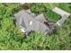 Aerial view of a well-maintained home featuring a gray roof, chimney, and mature trees surrounding the property at 10919 Running Tide Ct, Indianapolis, IN 46236