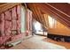 Unfinished attic space showcasing exposed wooden beams, insulation, and potential for expansion and customization at 10919 Running Tide Ct, Indianapolis, IN 46236