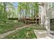 Picturesque backyard with a tiered deck, natural landscaping, and lush greenery, perfect for outdoor enjoyment at 10919 Running Tide Ct, Indianapolis, IN 46236
