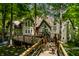 Beautiful home featuring a private backyard with a large deck surrounded by trees and a blue hammock at 10919 Running Tide Ct, Indianapolis, IN 46236