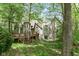 Exterior view of the home, showcasing the backyard deck amidst lush trees and foliage at 10919 Running Tide Ct, Indianapolis, IN 46236