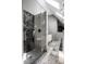 Modern bathroom with walk-in shower featuring glass doors and gray tiling at 10919 Running Tide Ct, Indianapolis, IN 46236