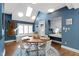 Sunlit dining area features wood table, white chairs, and blue walls, with a window seat at 10919 Running Tide Ct, Indianapolis, IN 46236