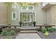 Inviting entryway with double doors, wooden benches, and manicured greenery at 10919 Running Tide Ct, Indianapolis, IN 46236