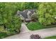 Attractive home with a well-manicured lawn, mature trees, and a paved driveway, situated in a peaceful, green neighborhood at 10919 Running Tide Ct, Indianapolis, IN 46236