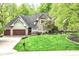 Beautiful two-story brick home with a well-manicured lawn and mature trees at 10919 Running Tide Ct, Indianapolis, IN 46236