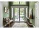 Elegant foyer with views to the landscaped yard, natural light, and stylish decor at 10919 Running Tide Ct, Indianapolis, IN 46236
