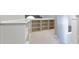Hallway featuring built in shelving with neutral carpet and white trim at 10919 Running Tide Ct, Indianapolis, IN 46236