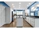 Bright kitchen features white cabinets, an island with black countertop, and stainless steel appliances at 10919 Running Tide Ct, Indianapolis, IN 46236