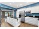 Bright kitchen featuring white cabinets, stainless appliances, island, and dark countertops at 10919 Running Tide Ct, Indianapolis, IN 46236