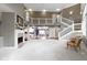 Open living space with vaulted ceilings, fireplace, and a view of the upper level and dining area at 10919 Running Tide Ct, Indianapolis, IN 46236