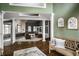 Open-concept living room with hardwood floors, white columns, and ample seating at 10919 Running Tide Ct, Indianapolis, IN 46236