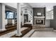 Open concept living space showcases a fireplace, staircase, and view into the adjacent kitchen at 10919 Running Tide Ct, Indianapolis, IN 46236