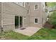 Exterior patio with glass sliding door, a cozy spot with easy indoor/outdoor access, nestled in a green landscape at 10919 Running Tide Ct, Indianapolis, IN 46236