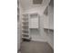 Bright walk-in closet with carpet floors, custom shelves and hanging rods at 10919 Running Tide Ct, Indianapolis, IN 46236