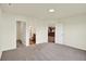 Carpeted bedroom with three doors leading to bathroom and kitchen areas at 110 Maxim Ct, Cumberland, IN 46229