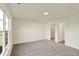 Carpeted bedroom with natural light, featuring closets and doorway to another room at 110 Maxim Ct, Cumberland, IN 46229