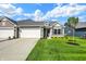 Charming home with a gray roof, two-car garage, stone accents, and a well-manicured lawn under a sunny sky at 110 Maxim Ct, Cumberland, IN 46229