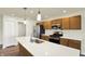 Modern kitchen features stainless steel appliances, wooden cabinets, quartz countertops, and a central island sink at 110 Maxim Ct, Cumberland, IN 46229
