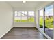 Bright sunroom with sliding glass door and large windows overlooking the backyard at 110 Maxim Ct, Cumberland, IN 46229