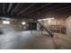 Unfinished basement with exposed wood beams, windows, and a stairwell at 11212 Bayridge E Cir, Indianapolis, IN 46236