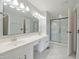 Bright bathroom boasts double vanity with sleek countertops and glass-enclosed shower at 11212 Bayridge E Cir, Indianapolis, IN 46236