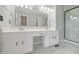 This bathroom features a double vanity with white cabinets and a modern glass shower at 11212 Bayridge E Cir, Indianapolis, IN 46236