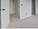 Carpeted bedroom showcasing neutral walls and view to closet or bathroom at 11212 Bayridge E Cir, Indianapolis, IN 46236