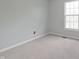 Bedroom featuring neutral walls, carpet flooring, and view of window at 11212 Bayridge E Cir, Indianapolis, IN 46236