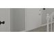 Close up on a white interior door with black hardware, light gray walls, white trim and gray laminate flooring at 11212 Bayridge E Cir, Indianapolis, IN 46236