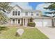 Traditional two-story home with gray siding, brick accents, well-manicured lawn and attached two-car garage at 11212 Bayridge E Cir, Indianapolis, IN 46236