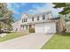 Charming two-story home featuring a two-car garage and well-maintained front yard with vibrant green grass at 11212 Bayridge E Cir, Indianapolis, IN 46236