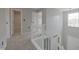 Upstairs hallway featuring carpet, fresh paint, and white staircase railing at 11212 Bayridge E Cir, Indianapolis, IN 46236